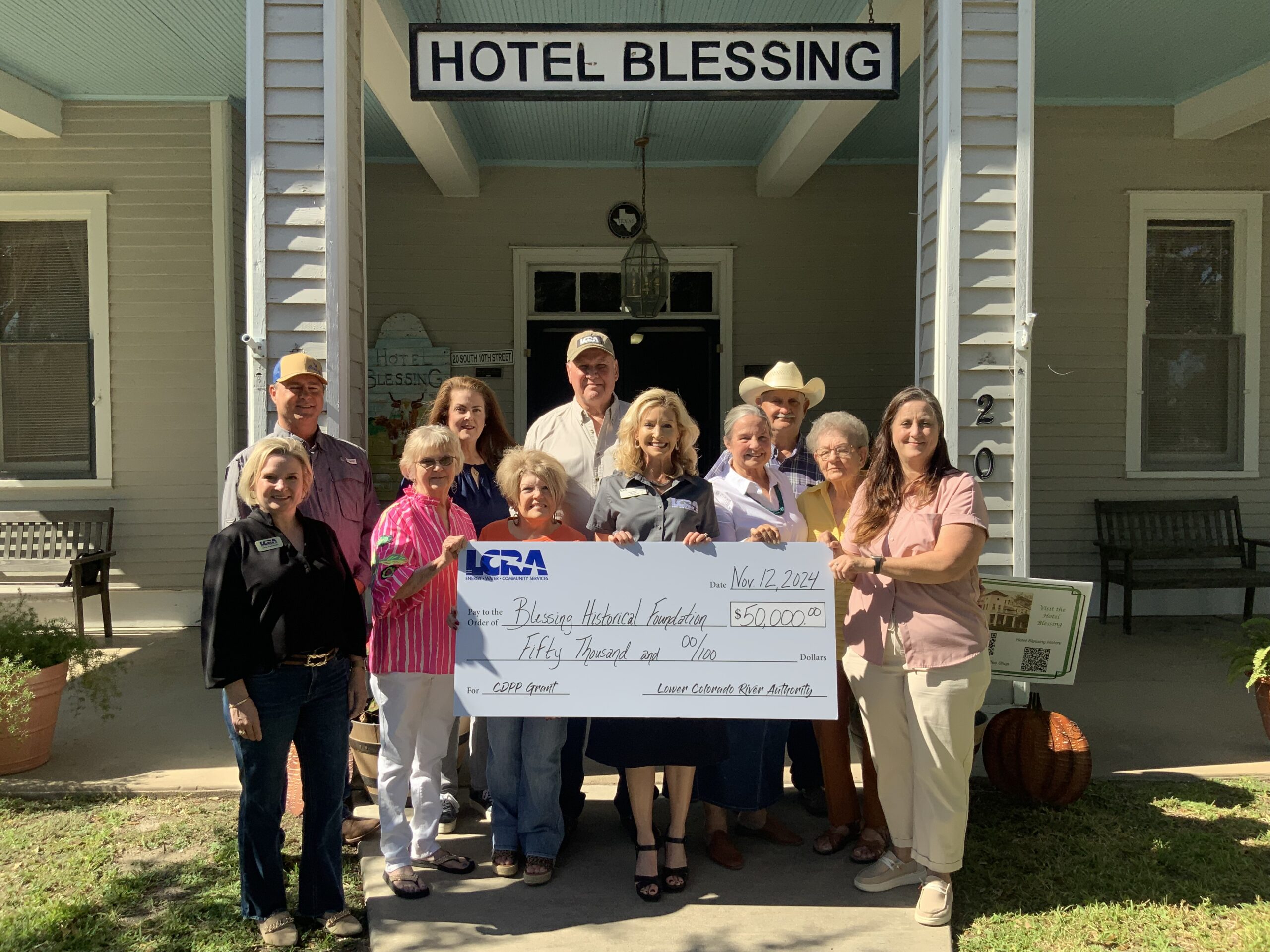 LCRA representatives present a $50,000 grant to the Blessing Historical Foundation to replace the roof at Hotel Blessing. The grant is part of LCRA’s Community Development Partnership Program. Pictured, from left to right, are: Kate Ramzinski, LCRA Regional Affairs representative; Eric Kacer and Twyla Greer, foundation members; Kimberley Cooper and Karen Bishop, community members; Stephen F. Cooper and Margaret D. “Meg” Voelter, LCRA Board members; Mary Pierce, foundation treasurer; Frederick Pierce, community member; Helen Feldousen, foundation member; and Jedie Pierce, foundation president.